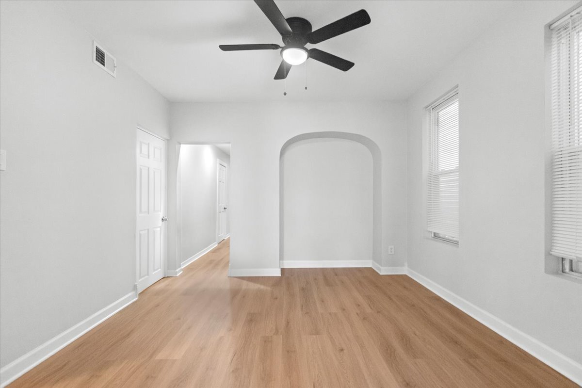 3709 North Troy Street, Unit 1 Chicago, IL 60618 - Photo 10 of 12 wooden floor in an empty room with a window