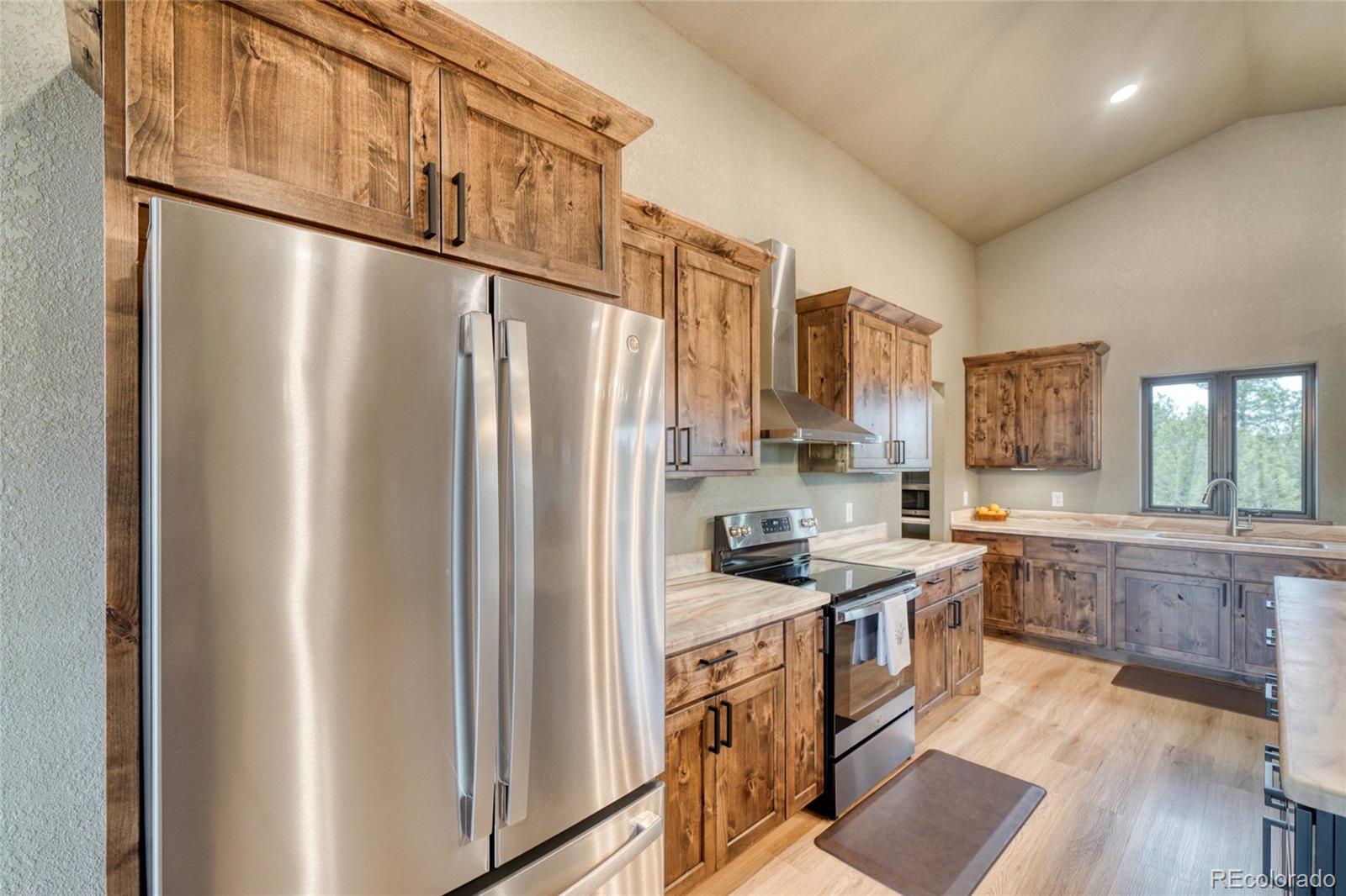 946 Hitching Post Road Cotopaxi, CO 81223 - Photo 17 of 50 a kitchen with stainless steel appliances granite countertop a refrigerator a stove a sink and a microwave