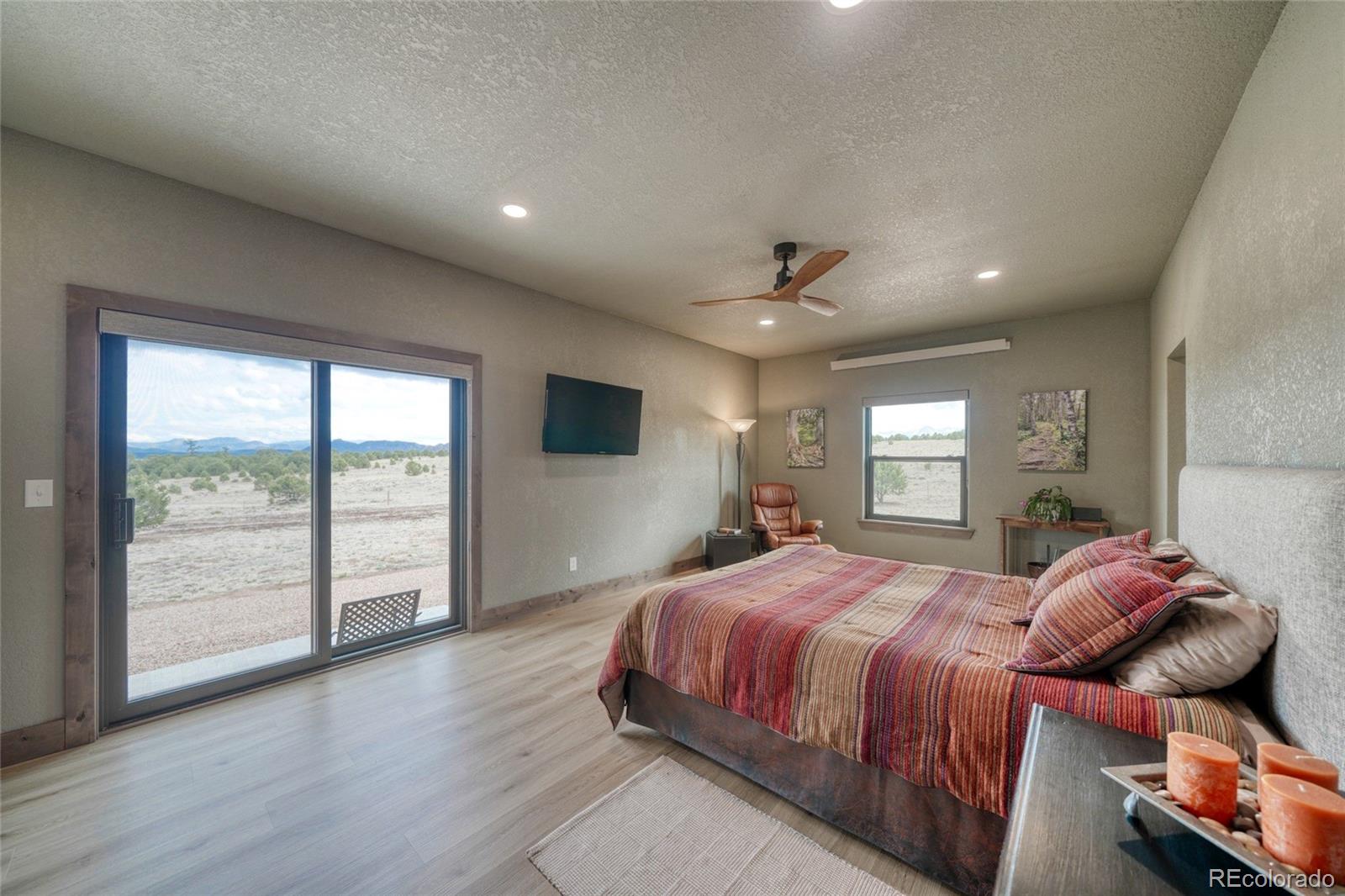 946 Hitching Post Road Cotopaxi, CO 81223 - Photo 26 of 50 a bedroom with a large bed and wooden floor