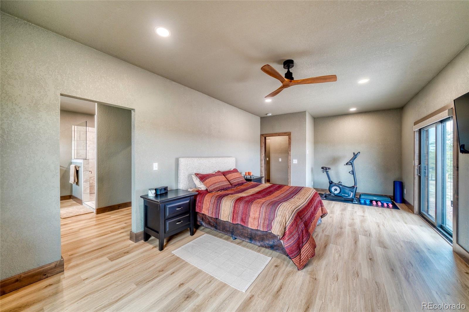 946 Hitching Post Road Cotopaxi, CO 81223 - Photo 28 of 50 a bedroom with a bed and a chandelier