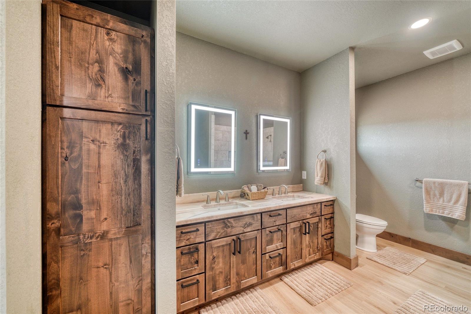 946 Hitching Post Road Cotopaxi, CO 81223 - Photo 30 of 50 a en suite bathroom with a granite countertop sink toilet and a mirror