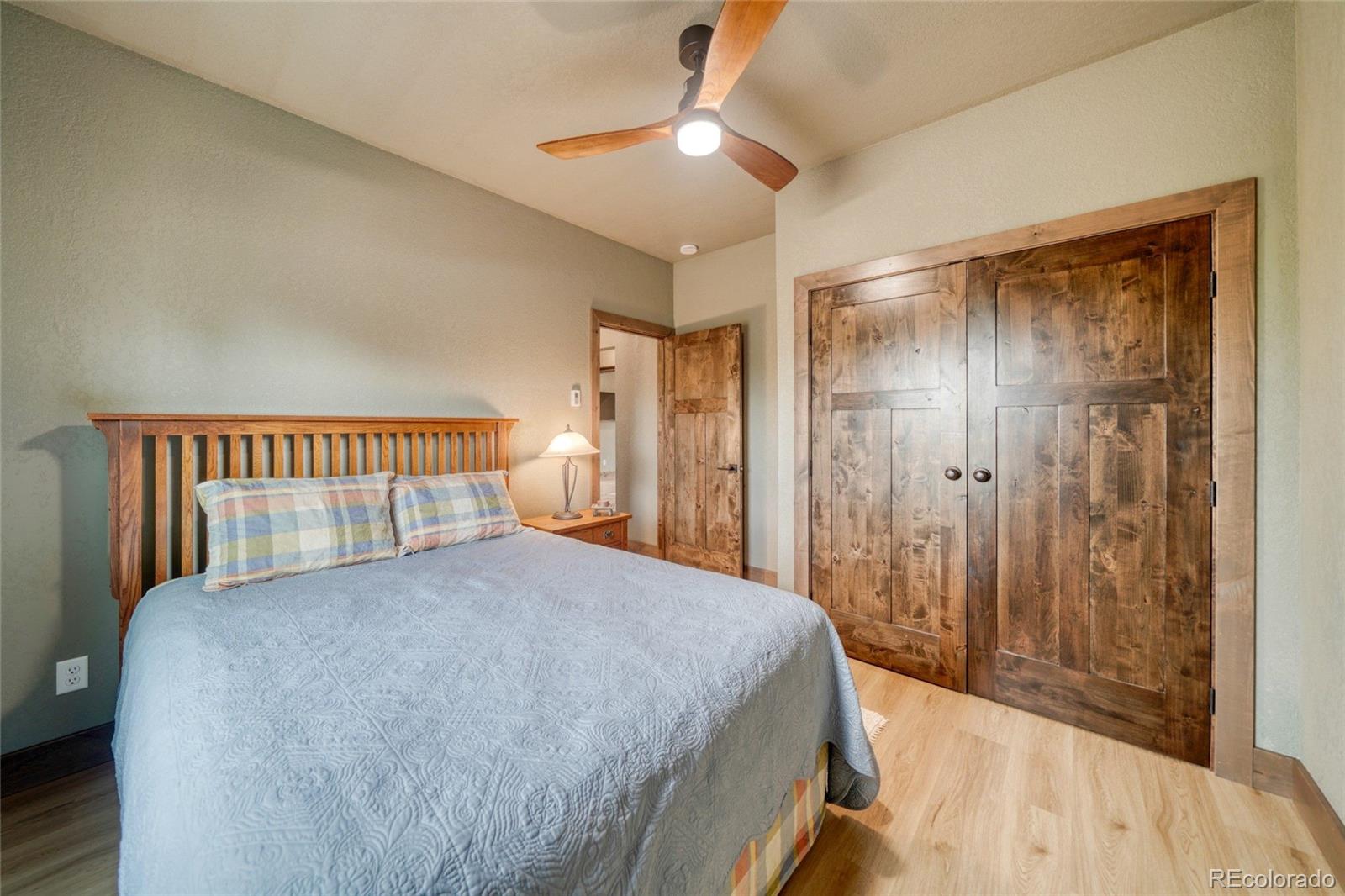 946 Hitching Post Road Cotopaxi, CO 81223 - Photo 37 of 50 a bedroom with a bed and a chandelier