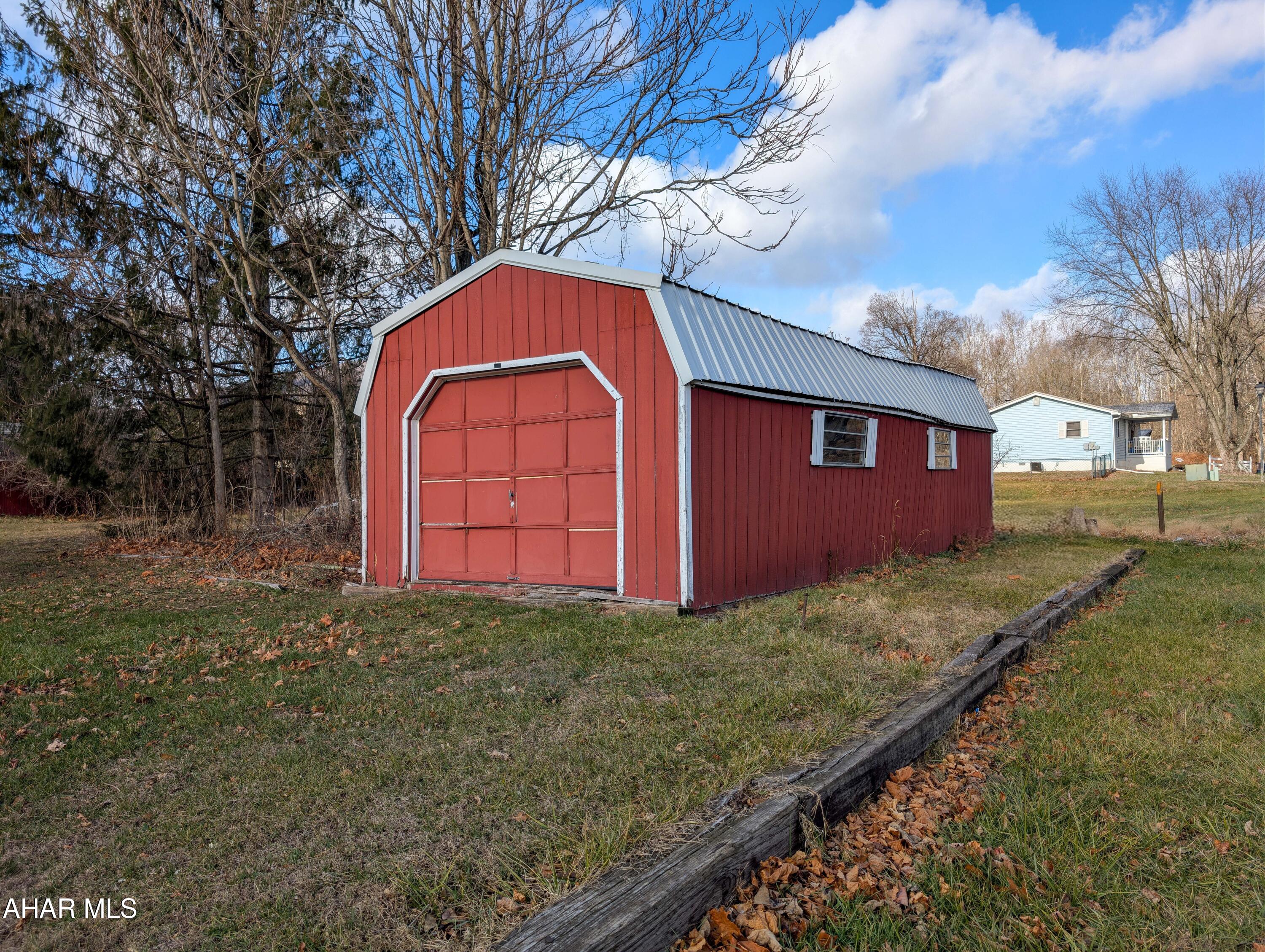 147 Pine Street Hyndman, PA 15545 - Photo 34 of 44 a view of a backyard with barn plants and large tree