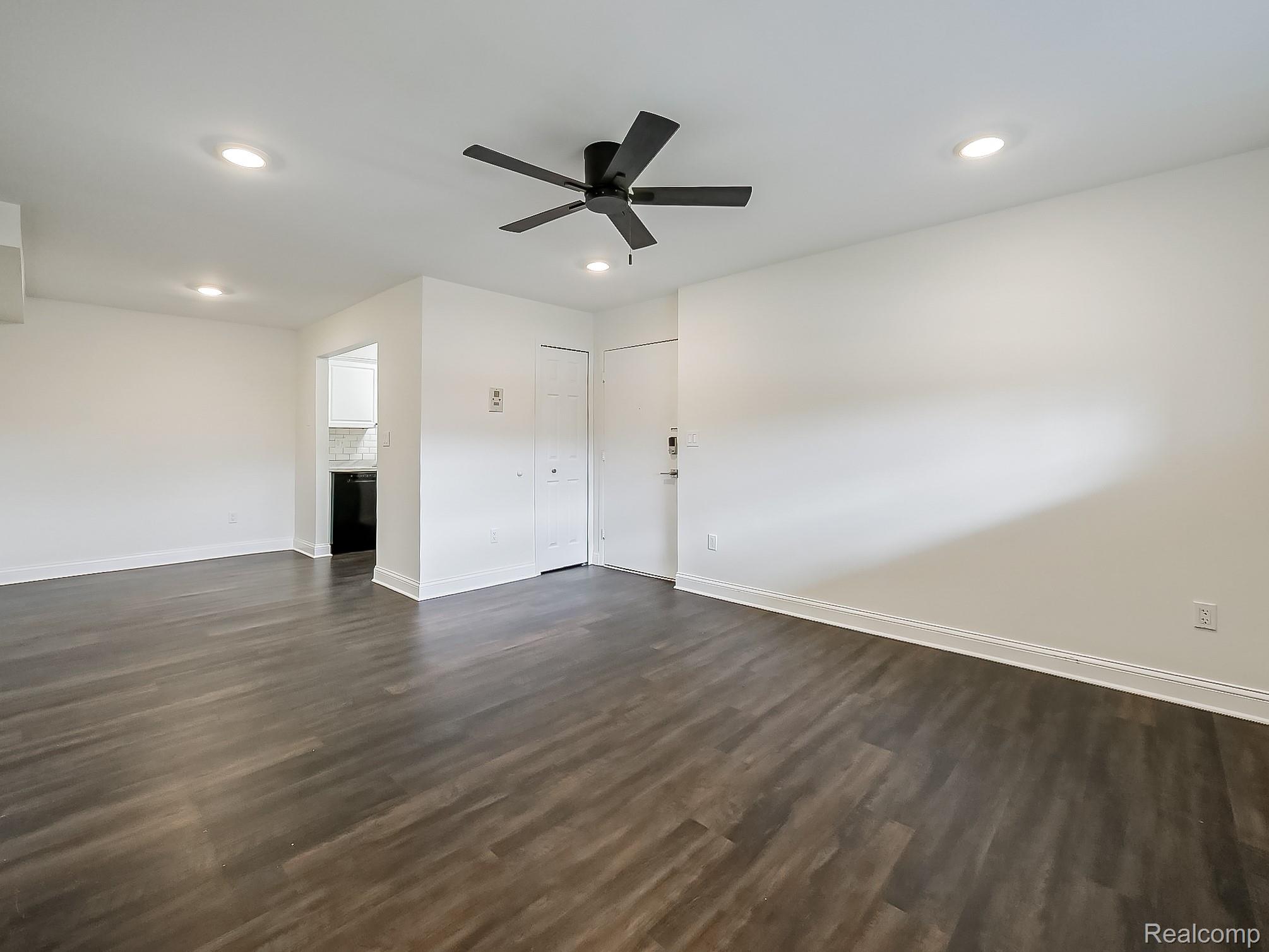 4905 South Crooks Road Royal Oak, MI 48073 - Photo 6 of 28 Unfurnished living room featuring ceiling fan, dark wood-type flooring, and recessed lighting