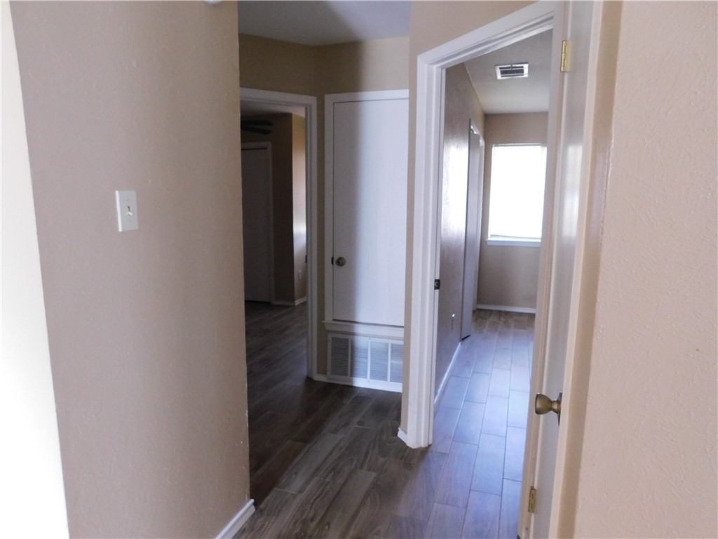 1900 Prairie Knoll Court, Unit A Austin, TX 78758 - Photo 12 of 18 a view of a hallway with wooden floor