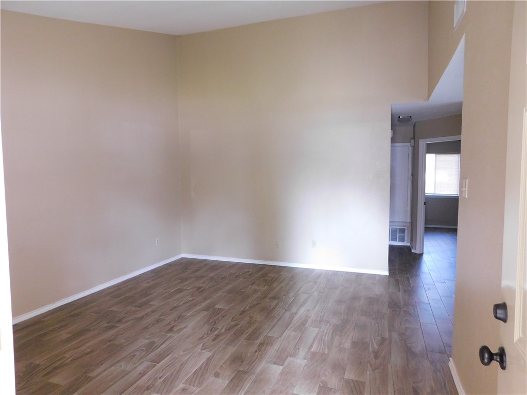 1900 Prairie Knoll Court, Unit A Austin, TX 78758 - Photo 3 of 18 a view of an empty room and wooden floor