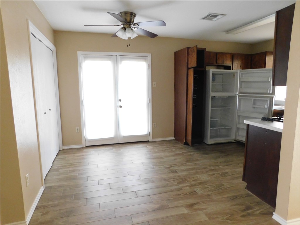 1900 Prairie Knoll Court, Unit A Austin, TX 78758 - Photo 4 of 18 wooden floor in an empty room with a window