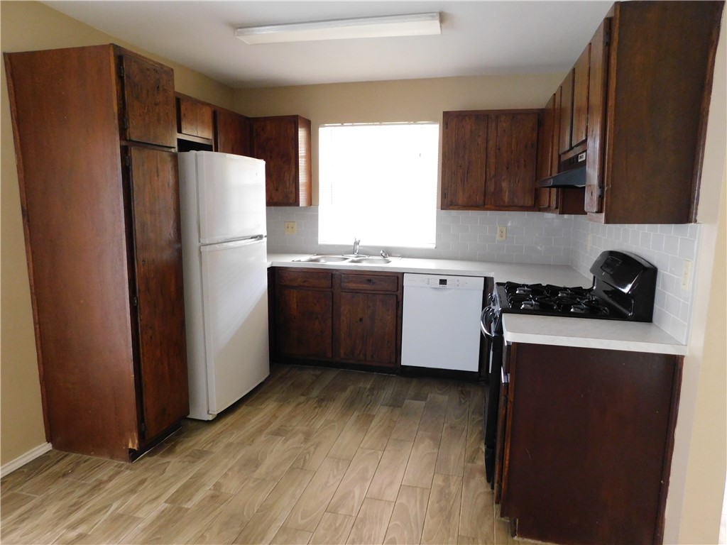 1900 Prairie Knoll Court, Unit A Austin, TX 78758 - Photo 5 of 18 a kitchen with stainless steel appliances a refrigerator and a sink