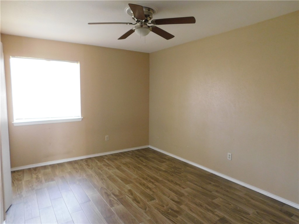1900 Prairie Knoll Court, Unit A Austin, TX 78758 - Photo 9 of 18 wooden floor in an empty room with a window