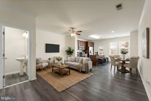 a living room with furniture wooden floor and a rug