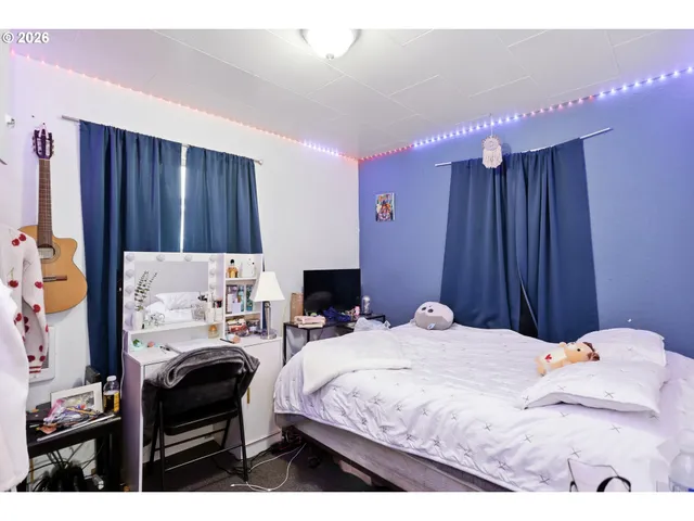 a bedroom with a bed and a chair