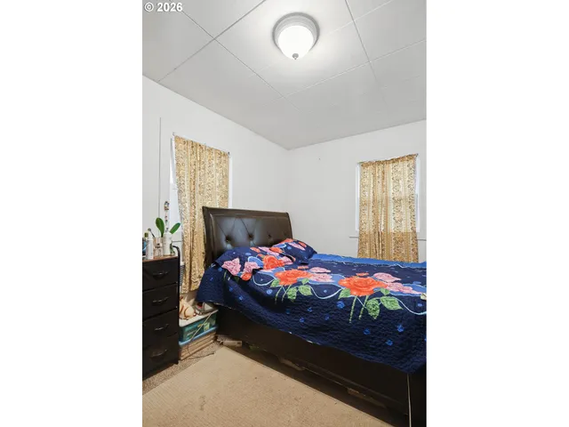 a bedroom with a bed and window