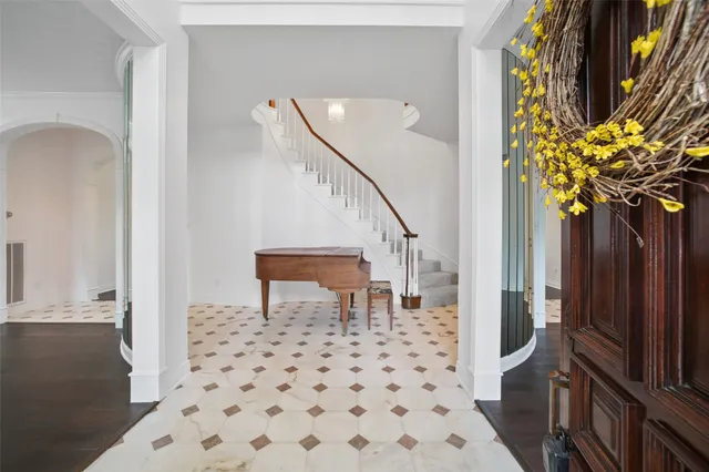 a dining room with furniture a chandelier and wooden floor