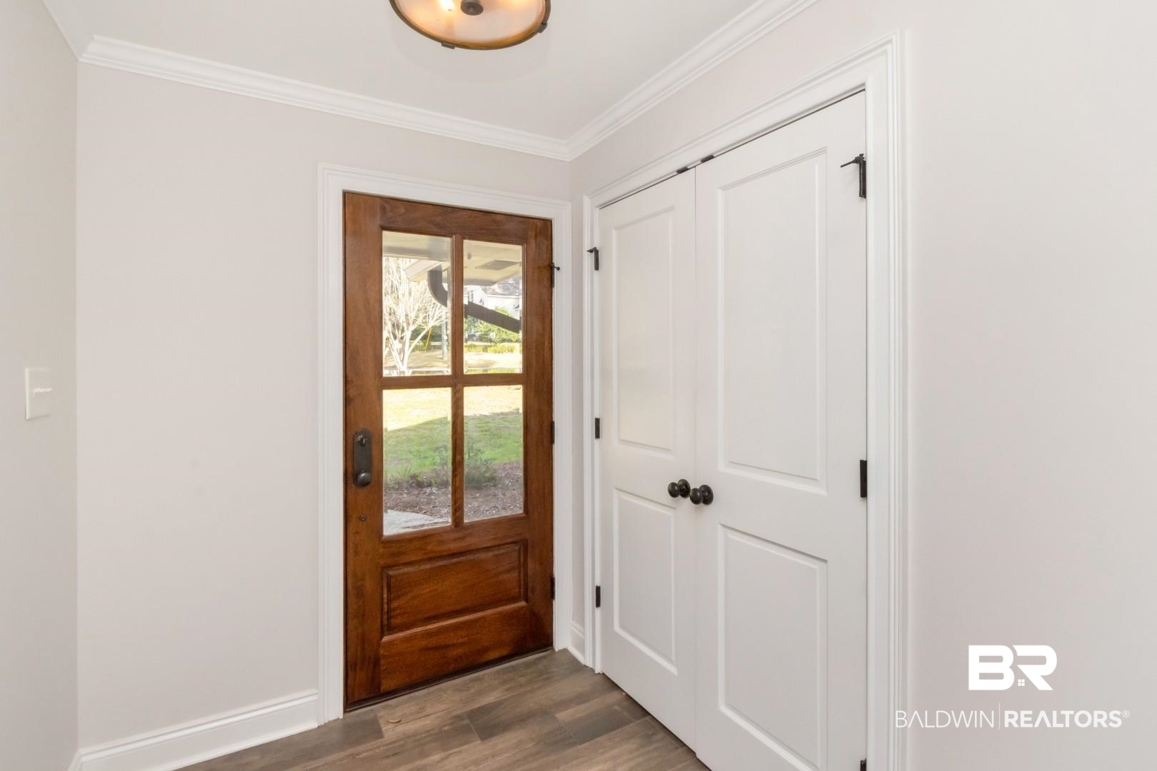 231 Rochester Road Mobile, AL 36608 - Photo 3 of 51 Doorway to outside with wood finished floors and crown molding