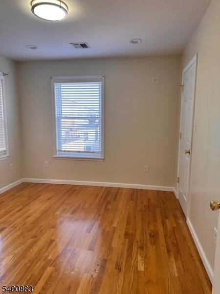 31 Morrell Street, Unit 2B Elizabeth, NJ 07201 - Photo 14 of 23 an empty room with wooden floor and windows