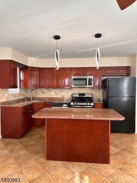 31 Morrell Street, Unit 2B Elizabeth, NJ 07201 - Photo 4 of 23 a kitchen with stainless steel appliances granite countertop a sink a stove and a refrigerator