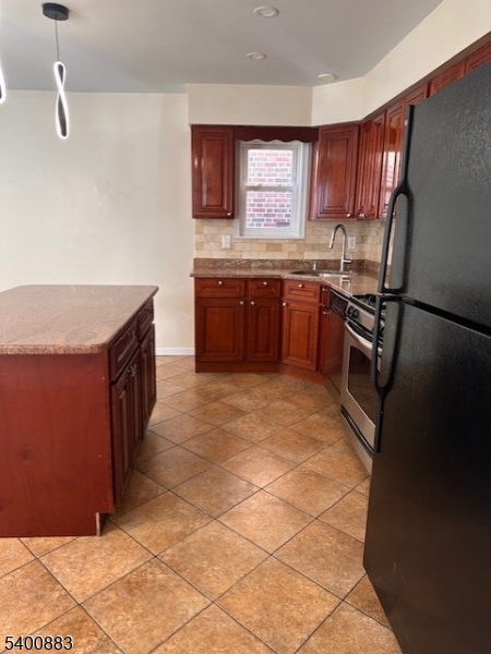 31 Morrell Street, Unit 2B Elizabeth, NJ 07201 - Photo 6 of 23 a kitchen with a stove top oven sink and cabinets