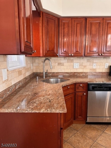 31 Morrell Street, Unit 2B Elizabeth, NJ 07201 - Photo 8 of 23 a kitchen with stainless steel appliances granite countertop wooden cabinets a sink and dishwasher