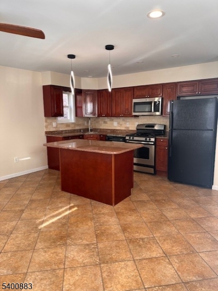 31 Morrell Street, Unit 2B Elizabeth, NJ 07201 - Photo 10 of 23 a kitchen with stainless steel appliances granite countertop a stove a sink dishwasher a refrigerator and a microwave