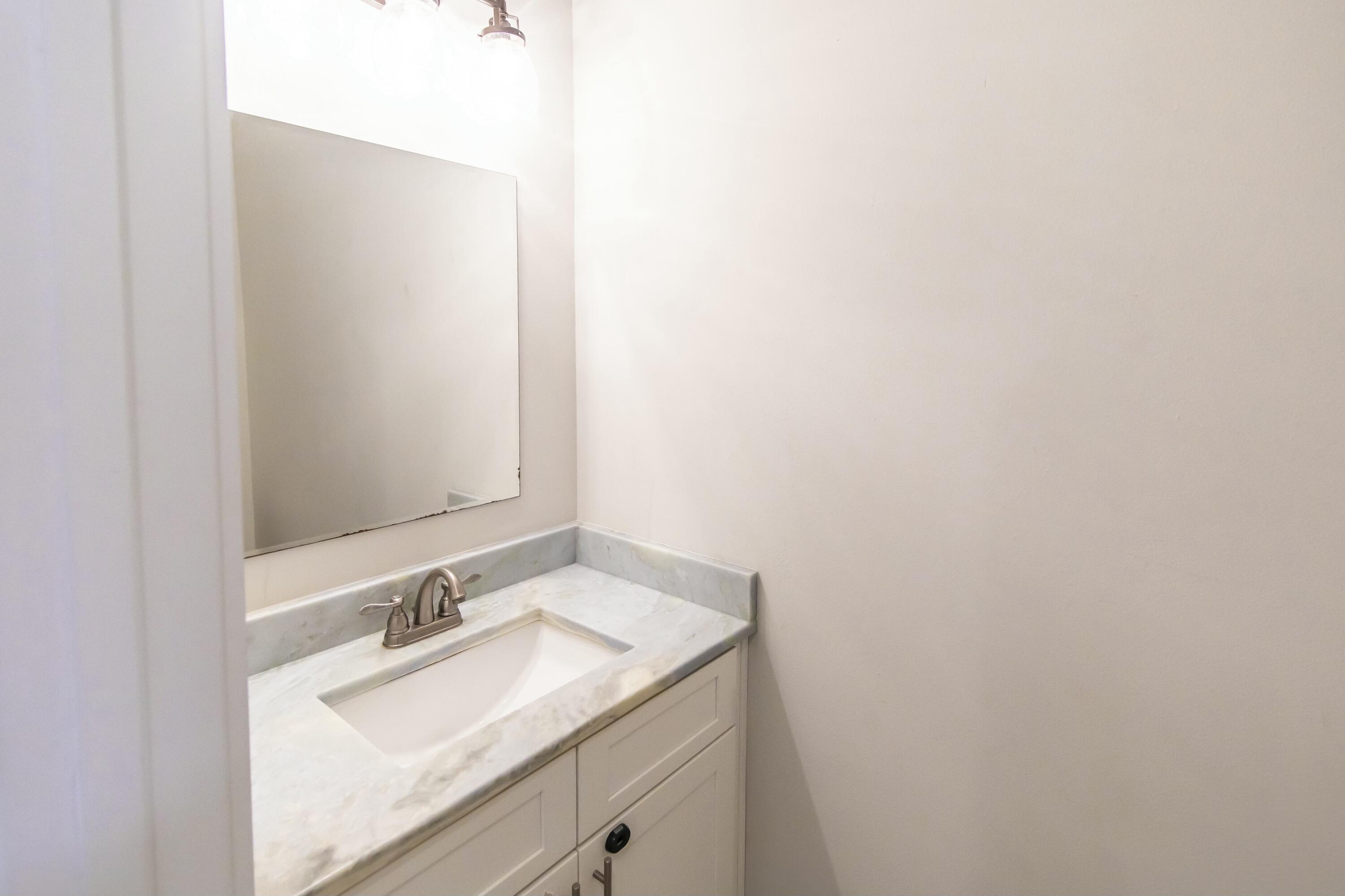 995 Airport Road, Unit 37 Destin, FL 32541 - Photo 13 of 46 a bathroom with a sink and a mirror