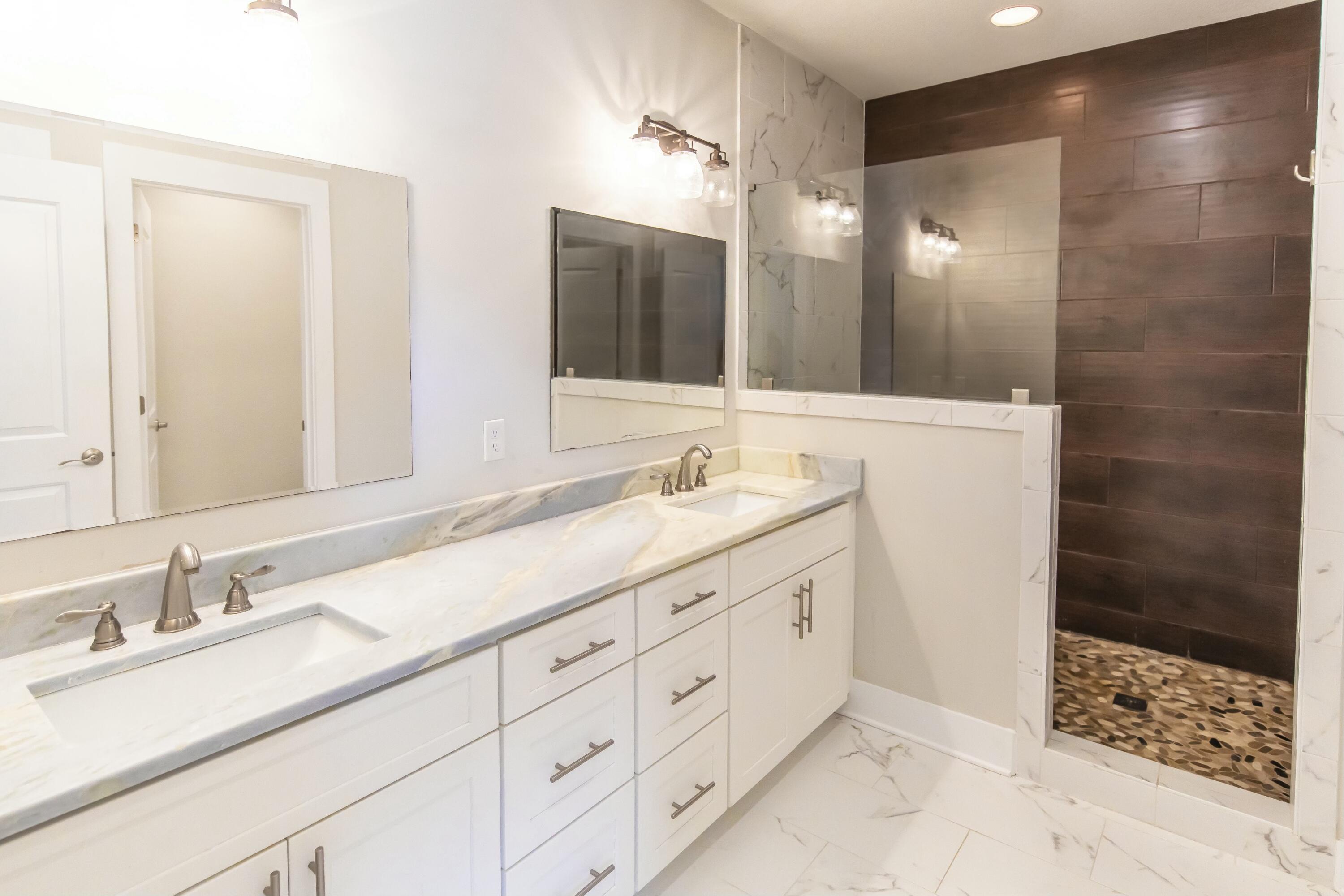 995 Airport Road, Unit 37 Destin, FL 32541 - Photo 25 of 46 a bathroom with double sink and a mirror