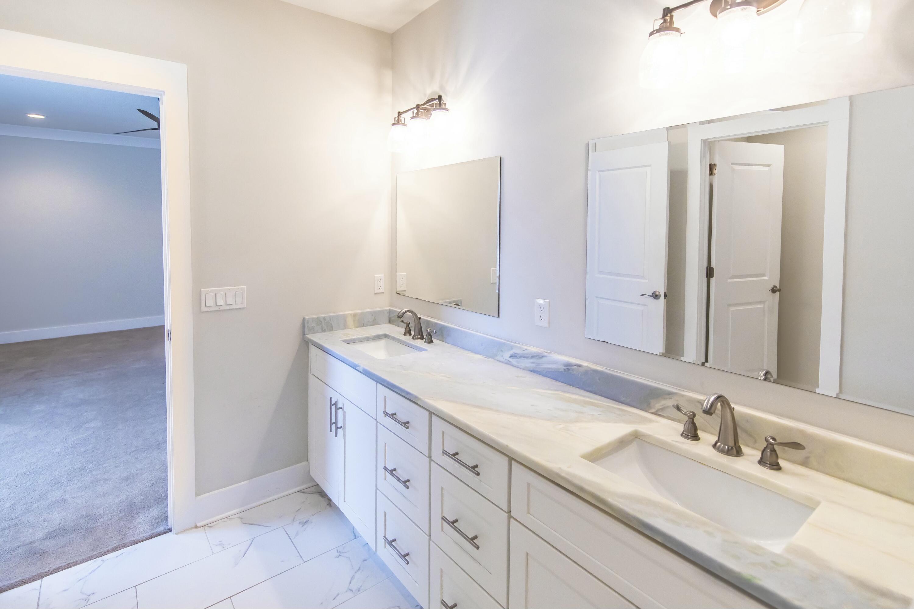 995 Airport Road, Unit 37 Destin, FL 32541 - Photo 28 of 46 a spacious bathroom with double sink and a mirror