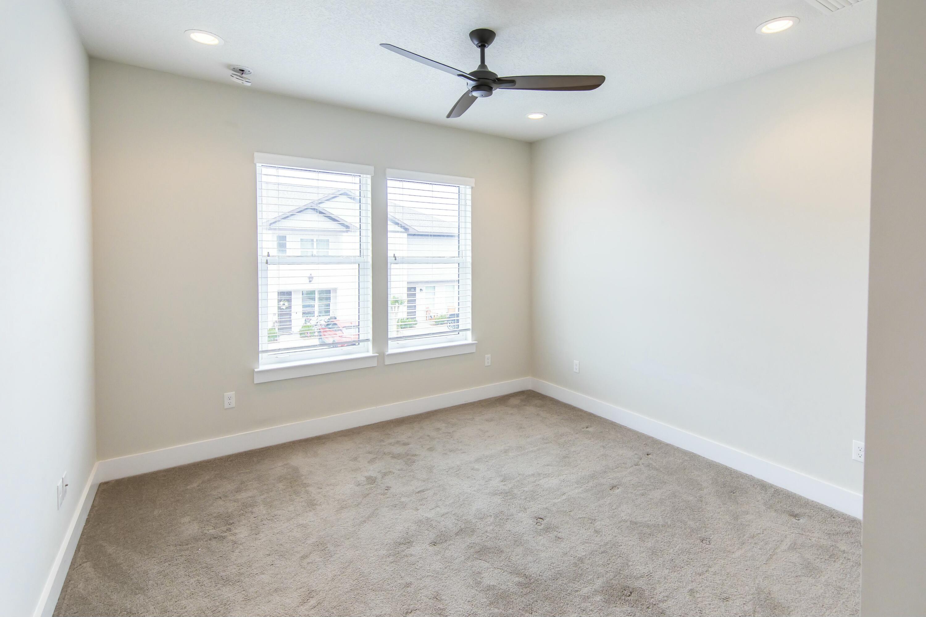 995 Airport Road, Unit 37 Destin, FL 32541 - Photo 30 of 46 an empty room with windows and fan