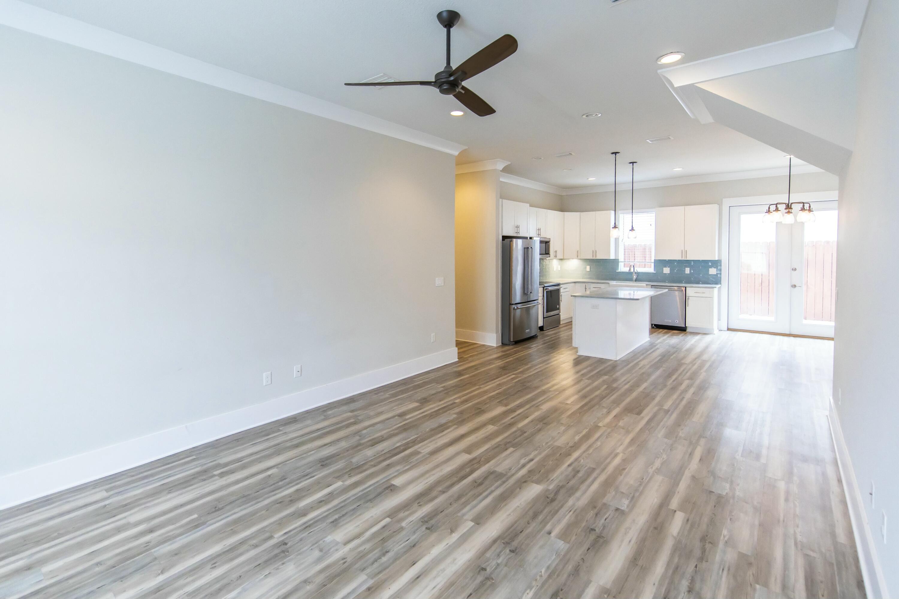 995 Airport Road, Unit 37 Destin, FL 32541 - Photo 3 of 46 a view of kitchen and empty room with wooden floor