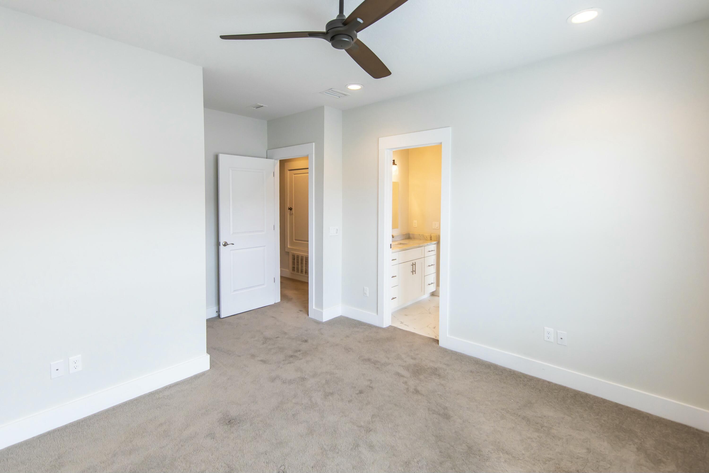 995 Airport Road, Unit 37 Destin, FL 32541 - Photo 31 of 46 an empty room with windows and ceiling fan