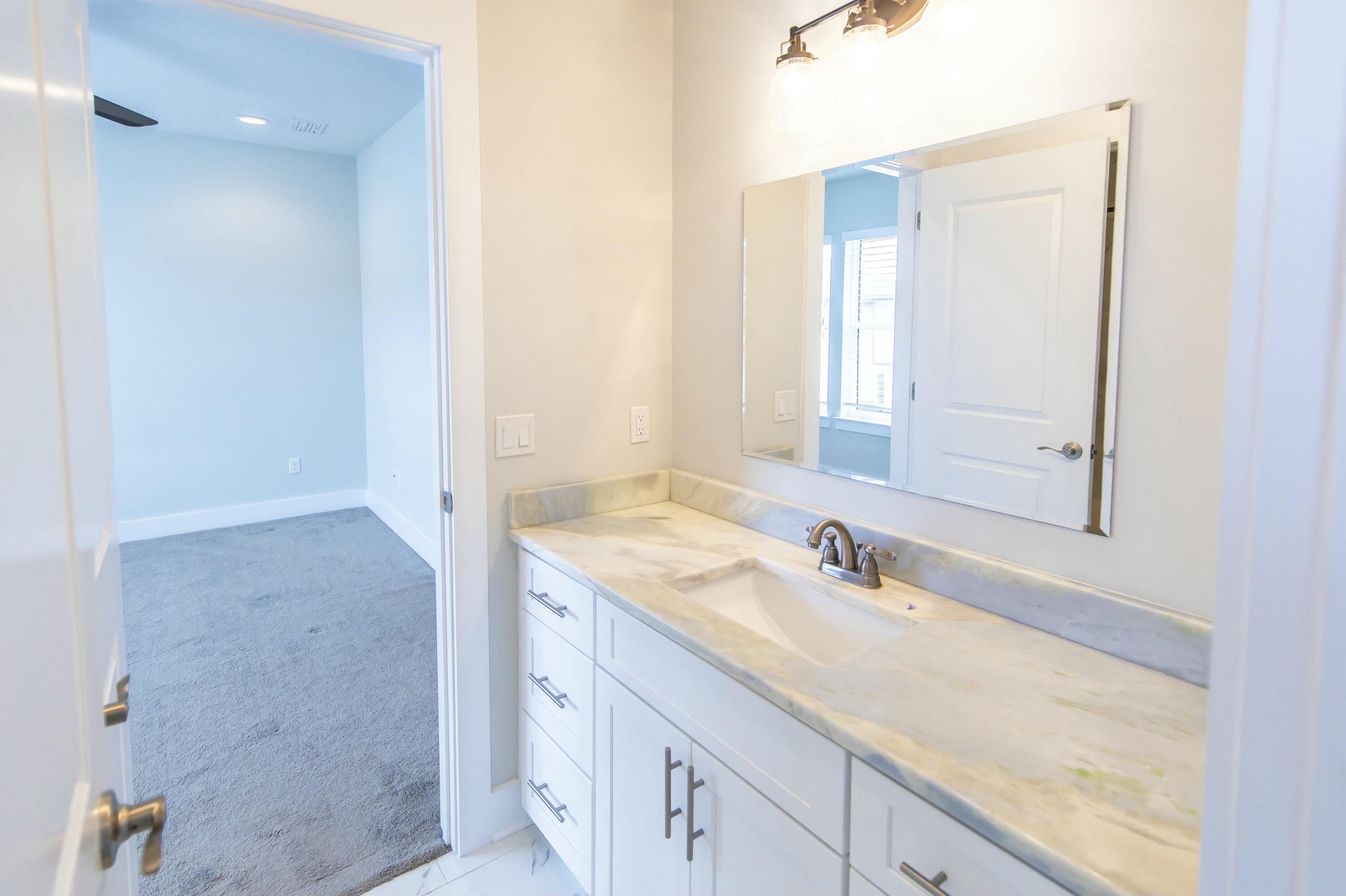 995 Airport Road, Unit 37 Destin, FL 32541 - Photo 32 of 46 a bathroom with a sink and a mirror