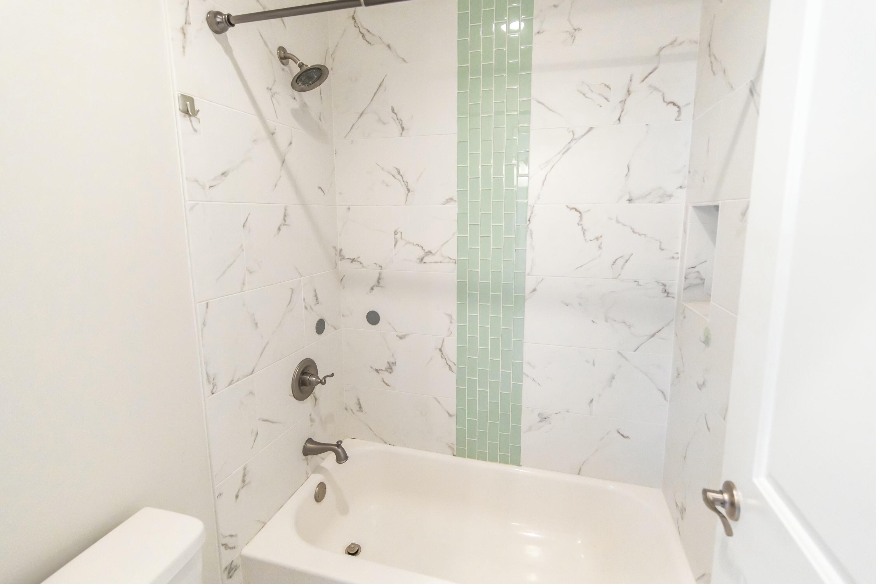 995 Airport Road, Unit 37 Destin, FL 32541 - Photo 33 of 46 a bathroom with a white bathtub and shower