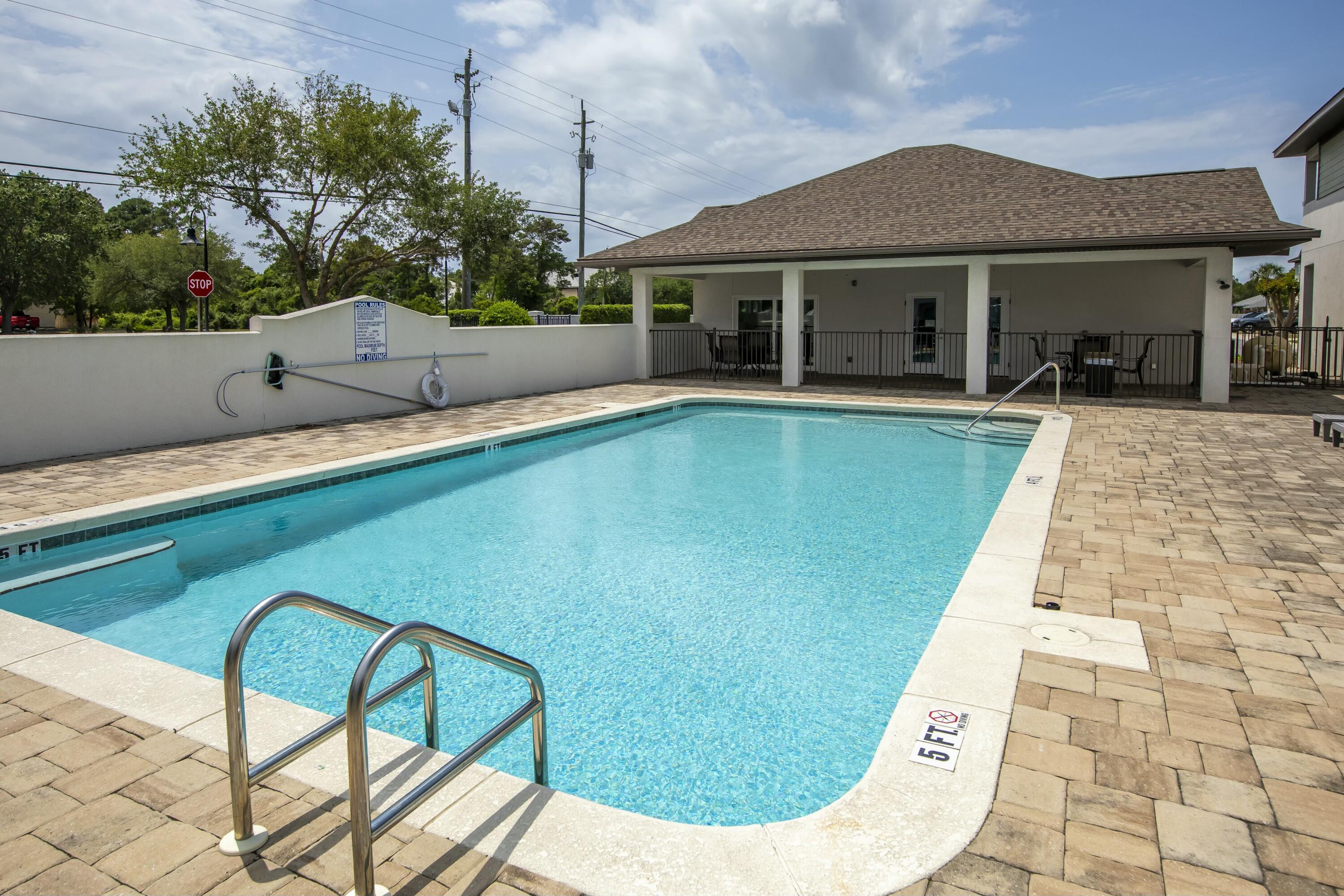 995 Airport Road, Unit 37 Destin, FL 32541 - Photo 43 of 46 a view of swimming pool from a lounge chair