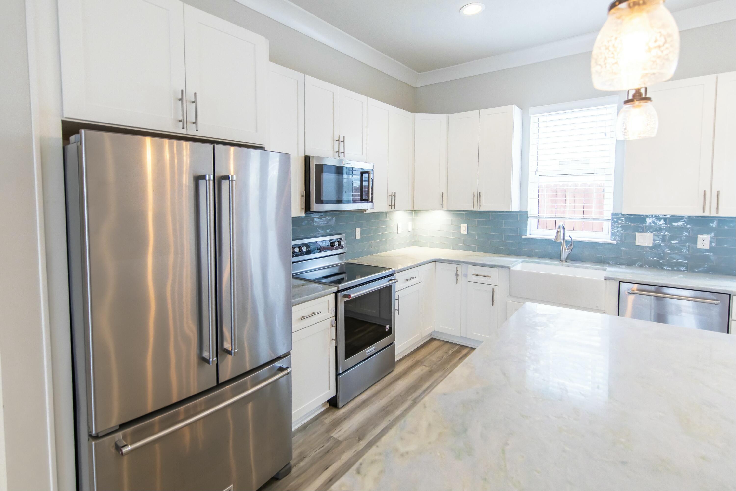 995 Airport Road, Unit 37 Destin, FL 32541 - Photo 8 of 46 a kitchen with stainless steel appliances a refrigerator sink and cabinets