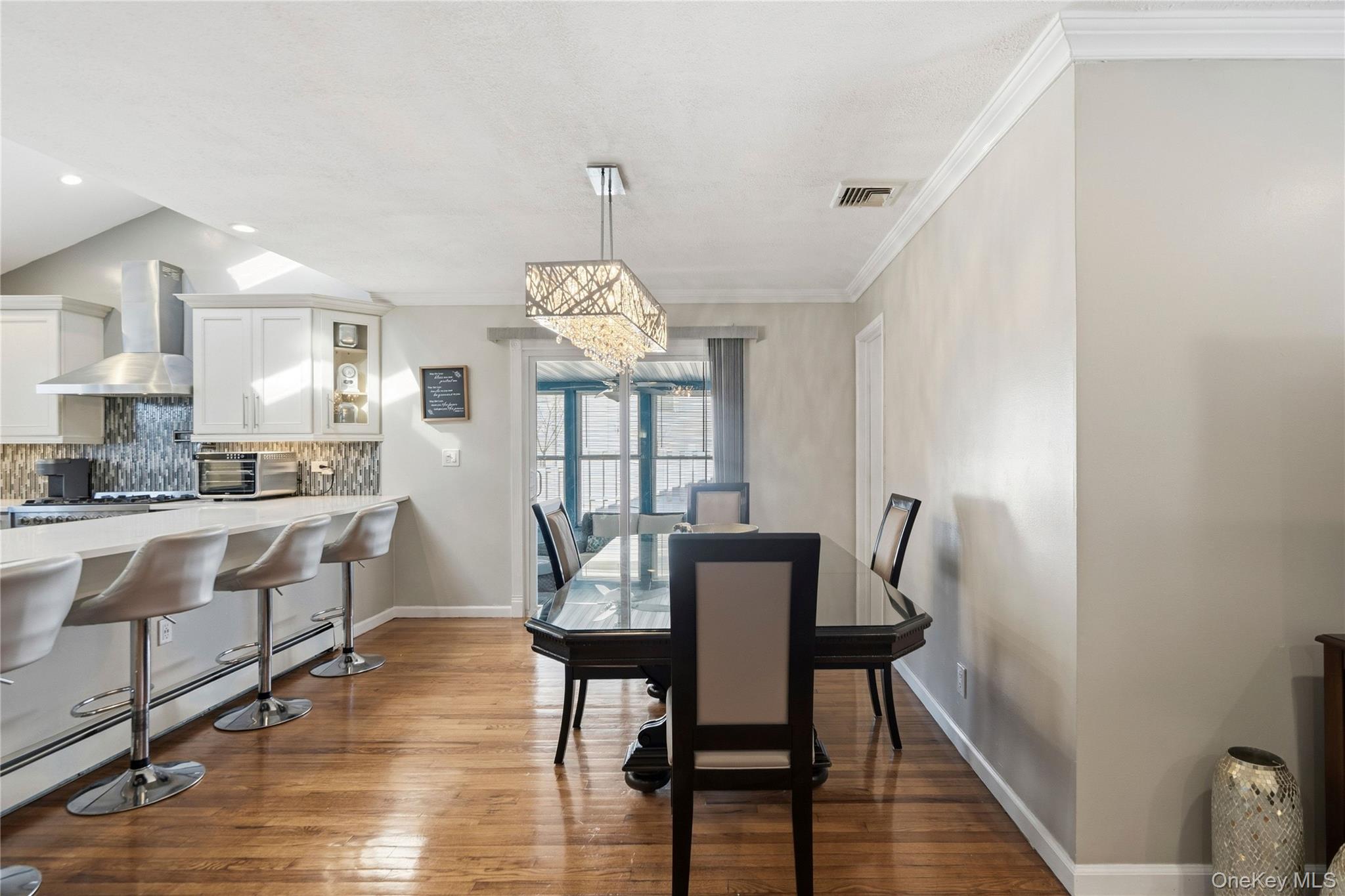 70 Forest Road Valley Stream, NY 11581 - Photo 11 of 43 a view of a dining room with furniture window and wooden floor