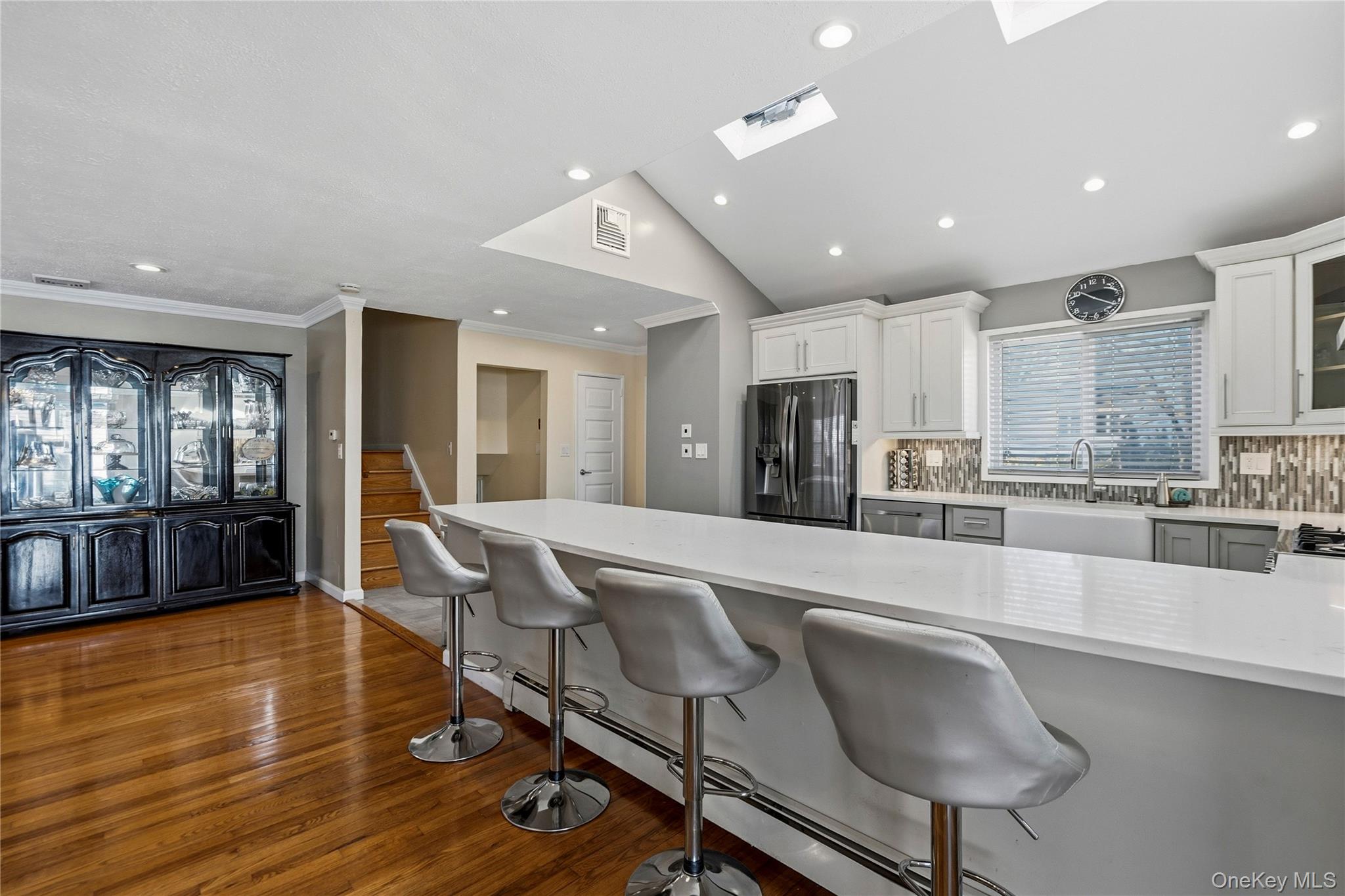 70 Forest Road Valley Stream, NY 11581 - Photo 13 of 43 a large dining hall with stainless steel appliances granite countertop a stove and a wooden floors