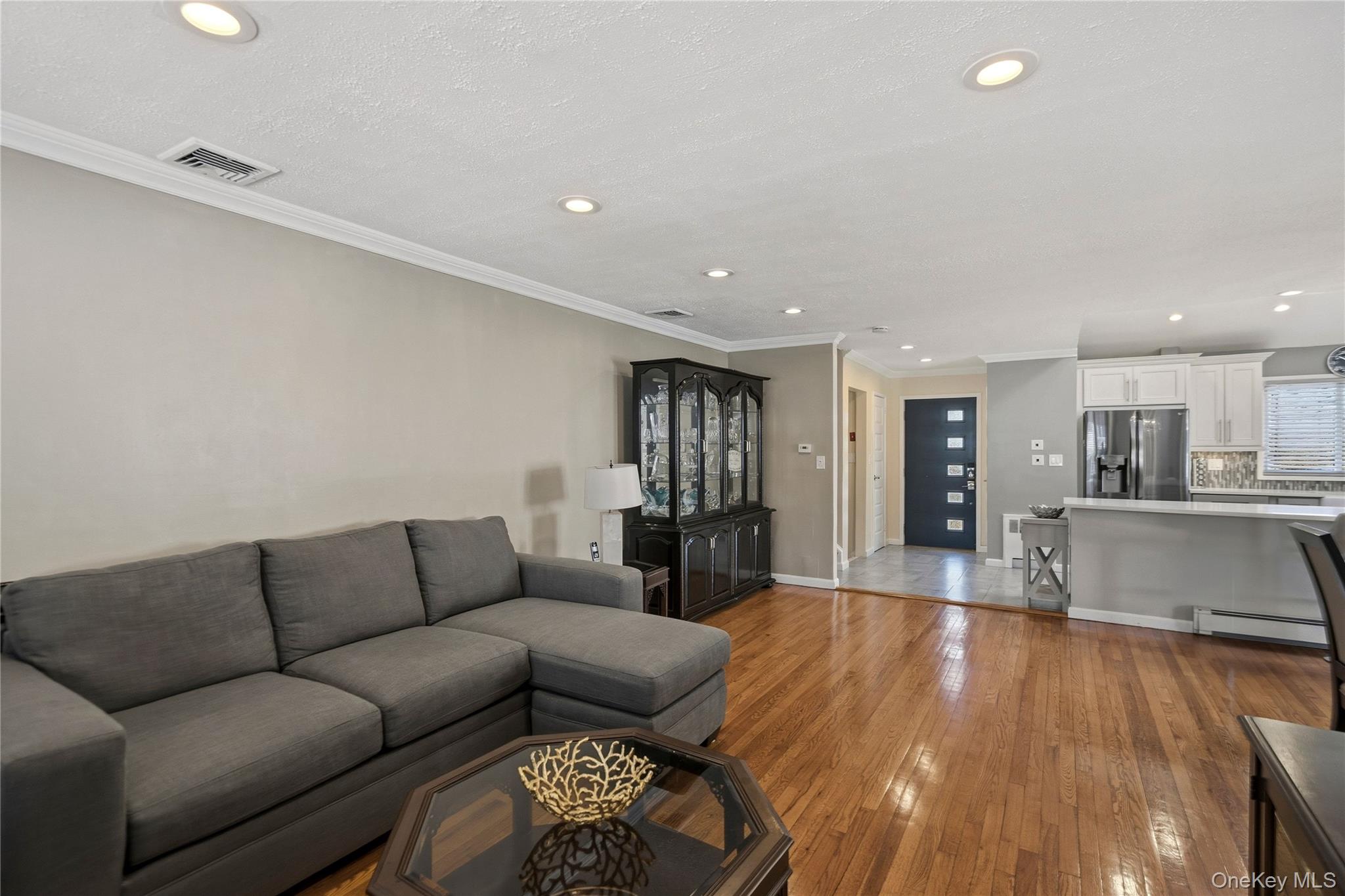 70 Forest Road Valley Stream, NY 11581 - Photo 16 of 43 a living room with furniture and kitchen view