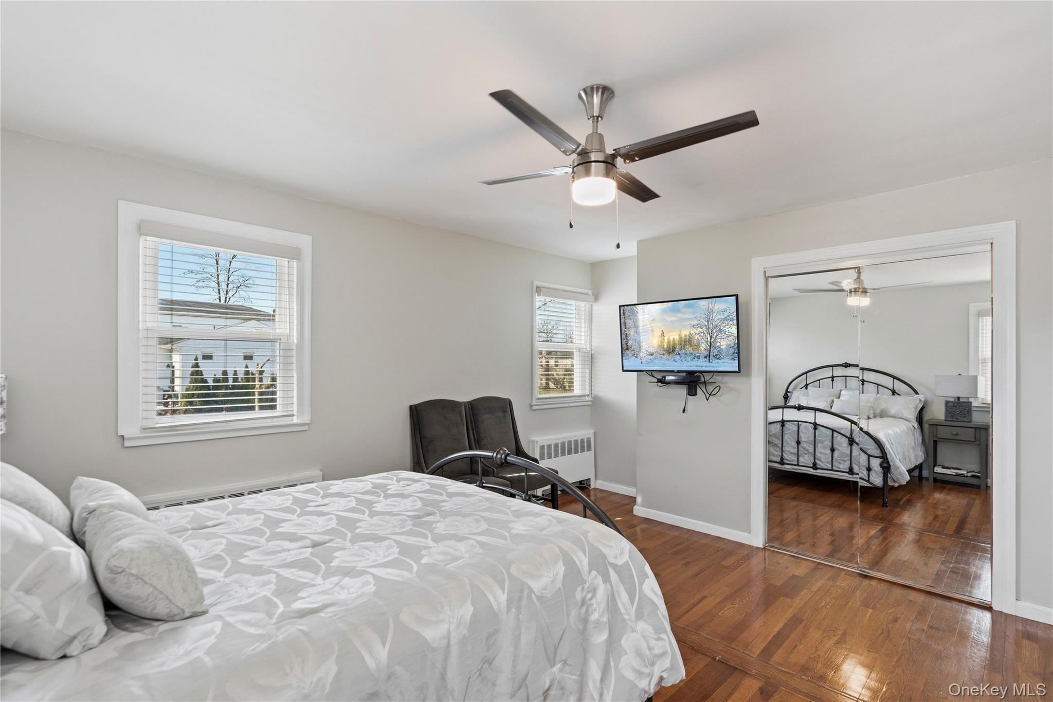 70 Forest Road Valley Stream, NY 11581 - Photo 22 of 43 a bedroom with a bed and a chandelier