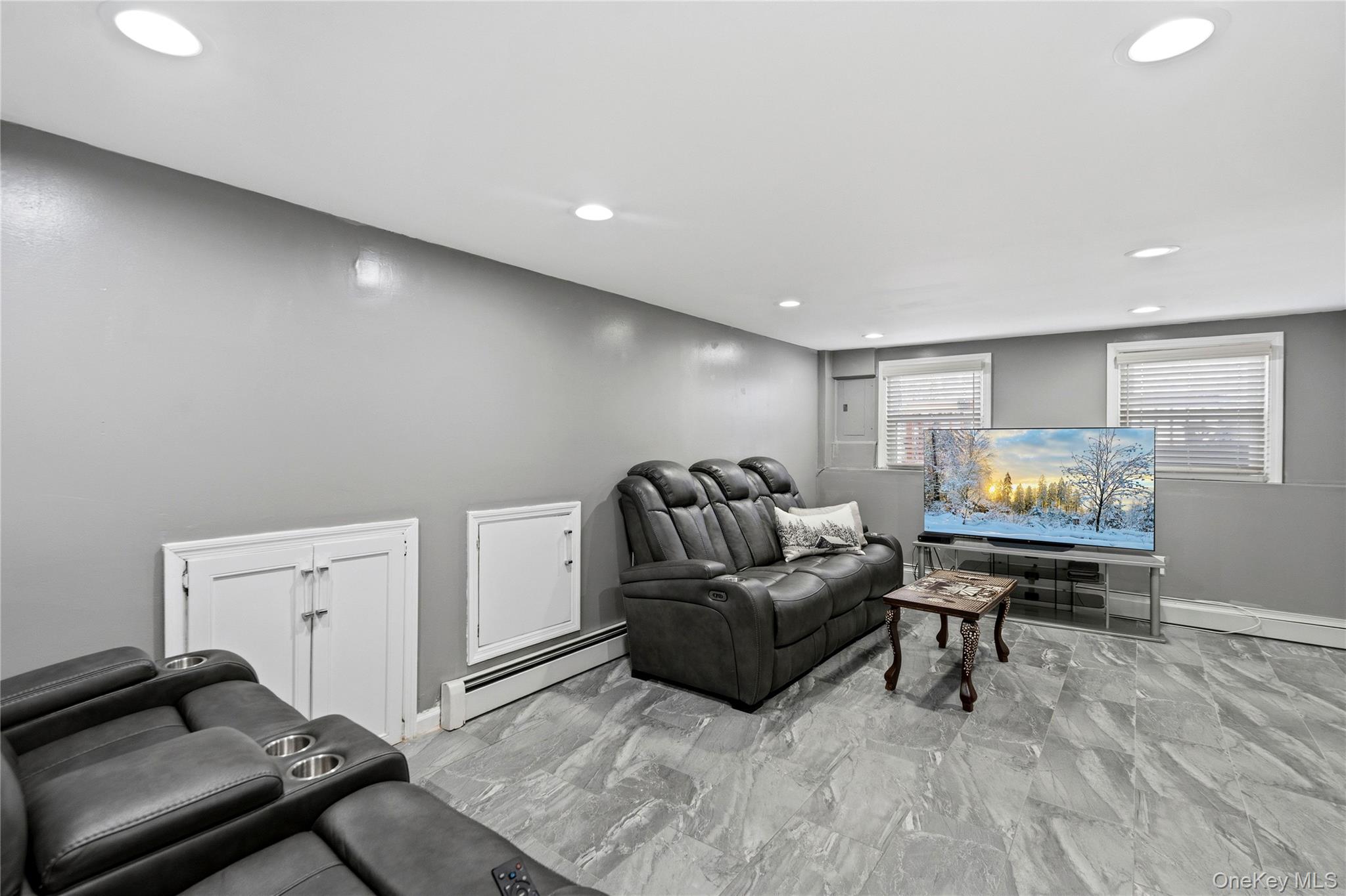 70 Forest Road Valley Stream, NY 11581 - Photo 24 of 43 a living room with furniture and a flat screen tv