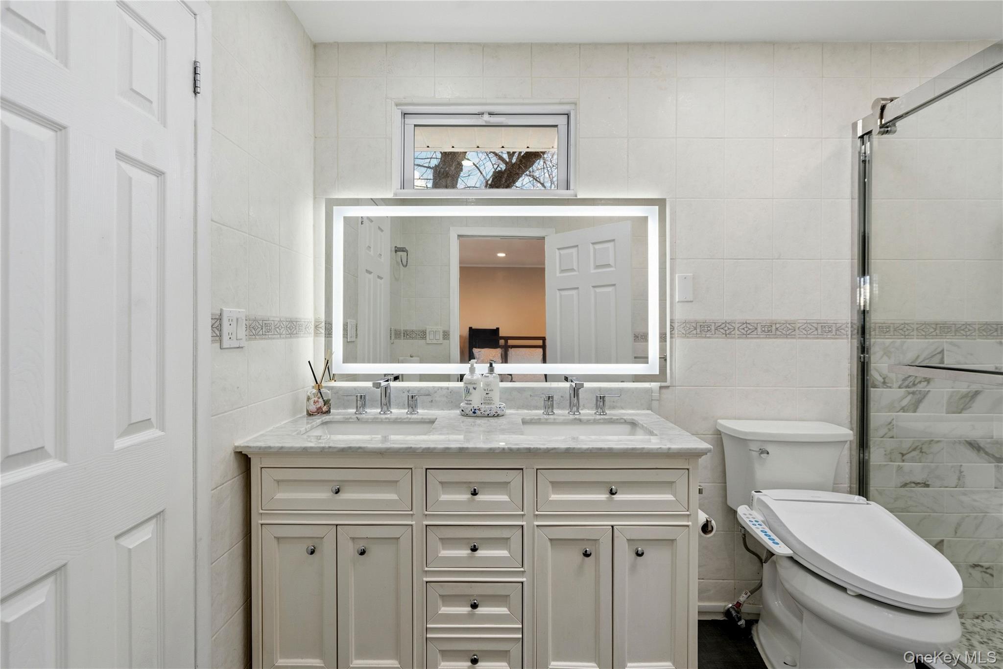 70 Forest Road Valley Stream, NY 11581 - Photo 29 of 43 a bathroom with a granite countertop toilet sink and a mirror