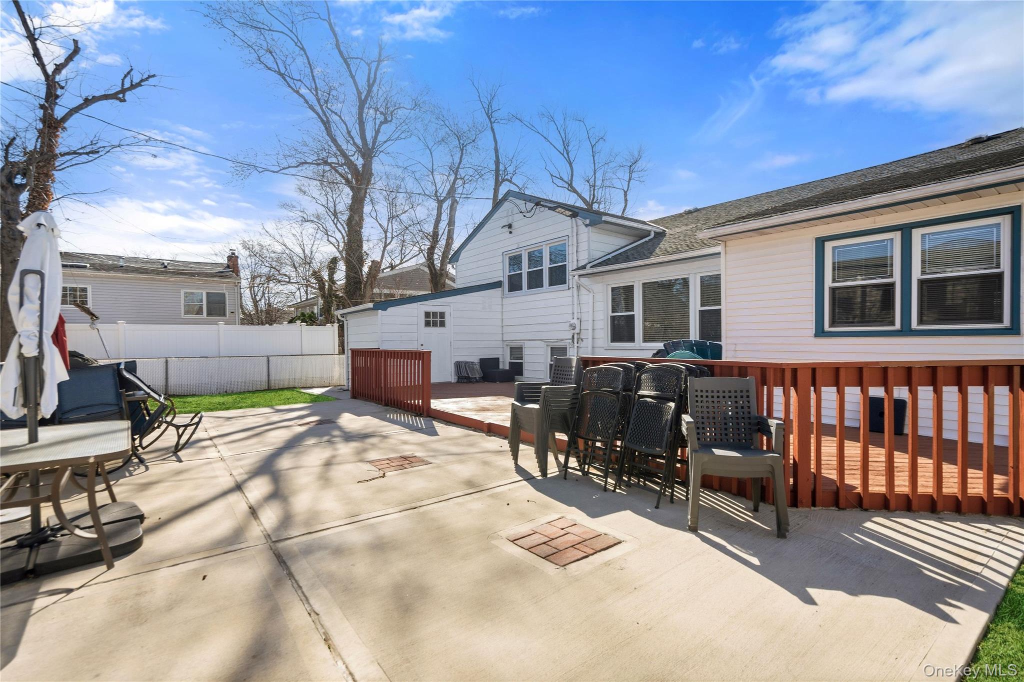 70 Forest Road Valley Stream, NY 11581 - Photo 35 of 43 a view of a chairs and tables in the back yard of the house
