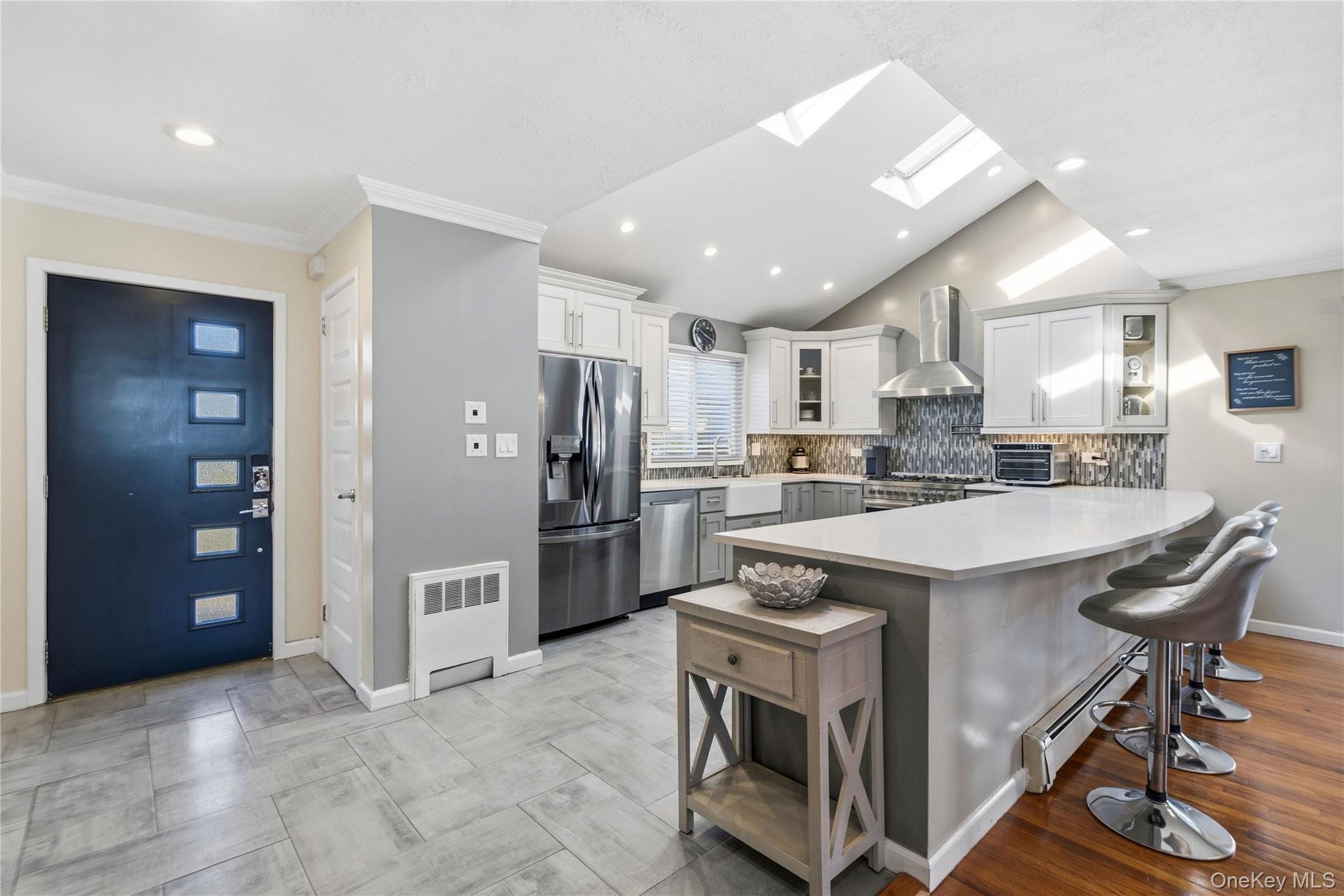 70 Forest Road Valley Stream, NY 11581 - Photo 5 of 43 a kitchen with stainless steel appliances granite countertop a stove a refrigerator and a refrigerator with wooden floor