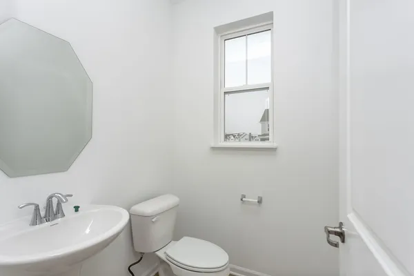 a white toilet sitting next to a bathroom sink