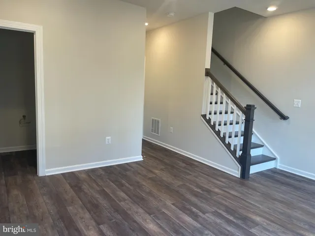 a view of an entryway with wooden floor