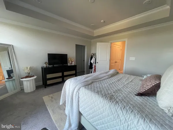 a bedroom with a bed and a television