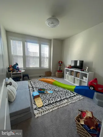 a living room with furniture a rug and a window