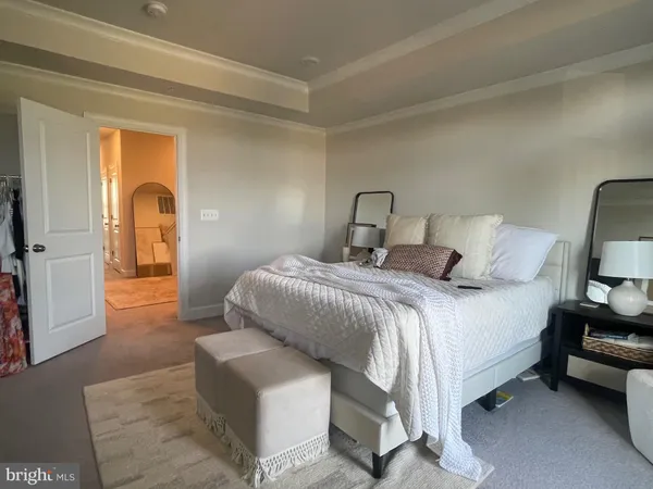 a bedroom with a bed and a mirror