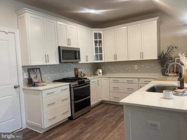 a kitchen with a sink stove and cabinets
