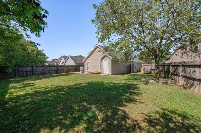 a view of a house with backyard and garden