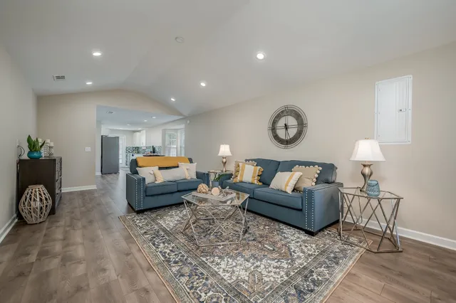 a living room with furniture and a lamp