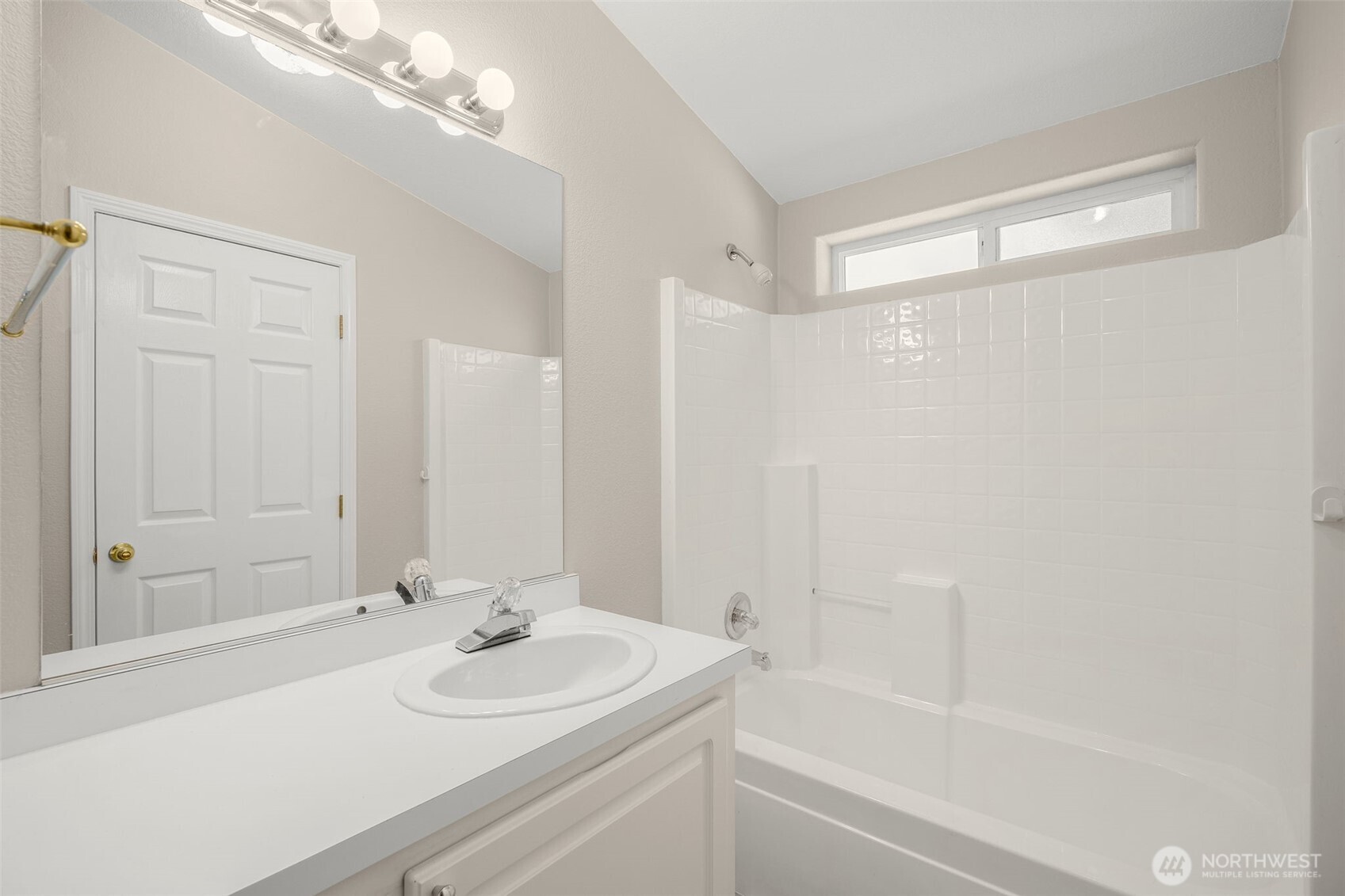 23606 Lake Drive West Bothell, WA 98021 - Photo 21 of 30 a bathroom with a sink a mirror and a shower